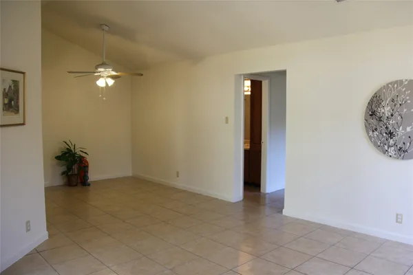 an empty room with closet and a chandelier fan