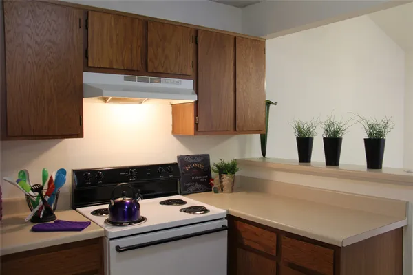 a kitchen with a sink cabinets and appliances