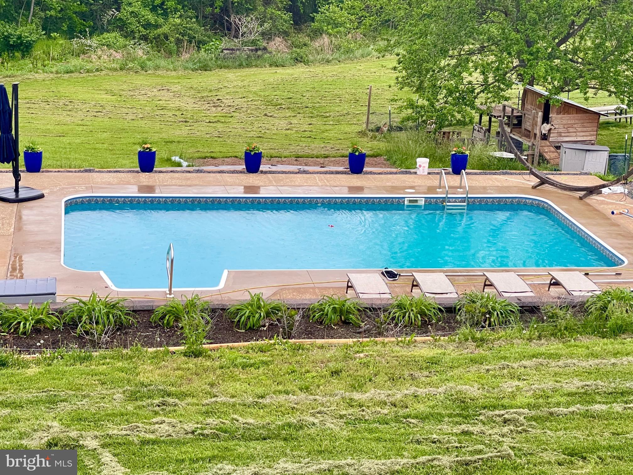 13028 Dreamers Path Culpeper, VA 22701 - Photo 3 of 13 a view of a swimming pool with a yard