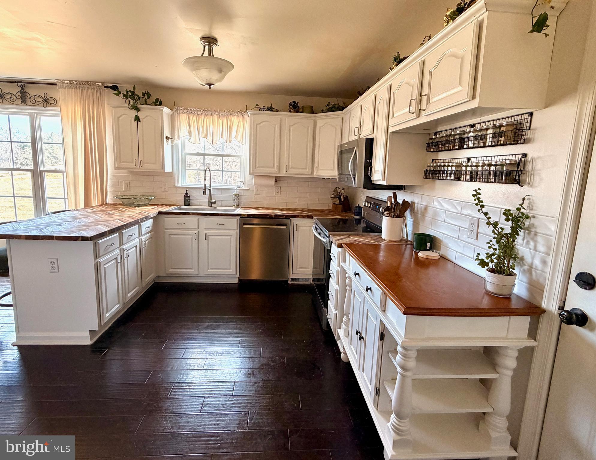 13028 Dreamers Path Culpeper, VA 22701 - Photo 5 of 13 a kitchen with stainless steel appliances granite countertop a sink a stove and a wooden floors