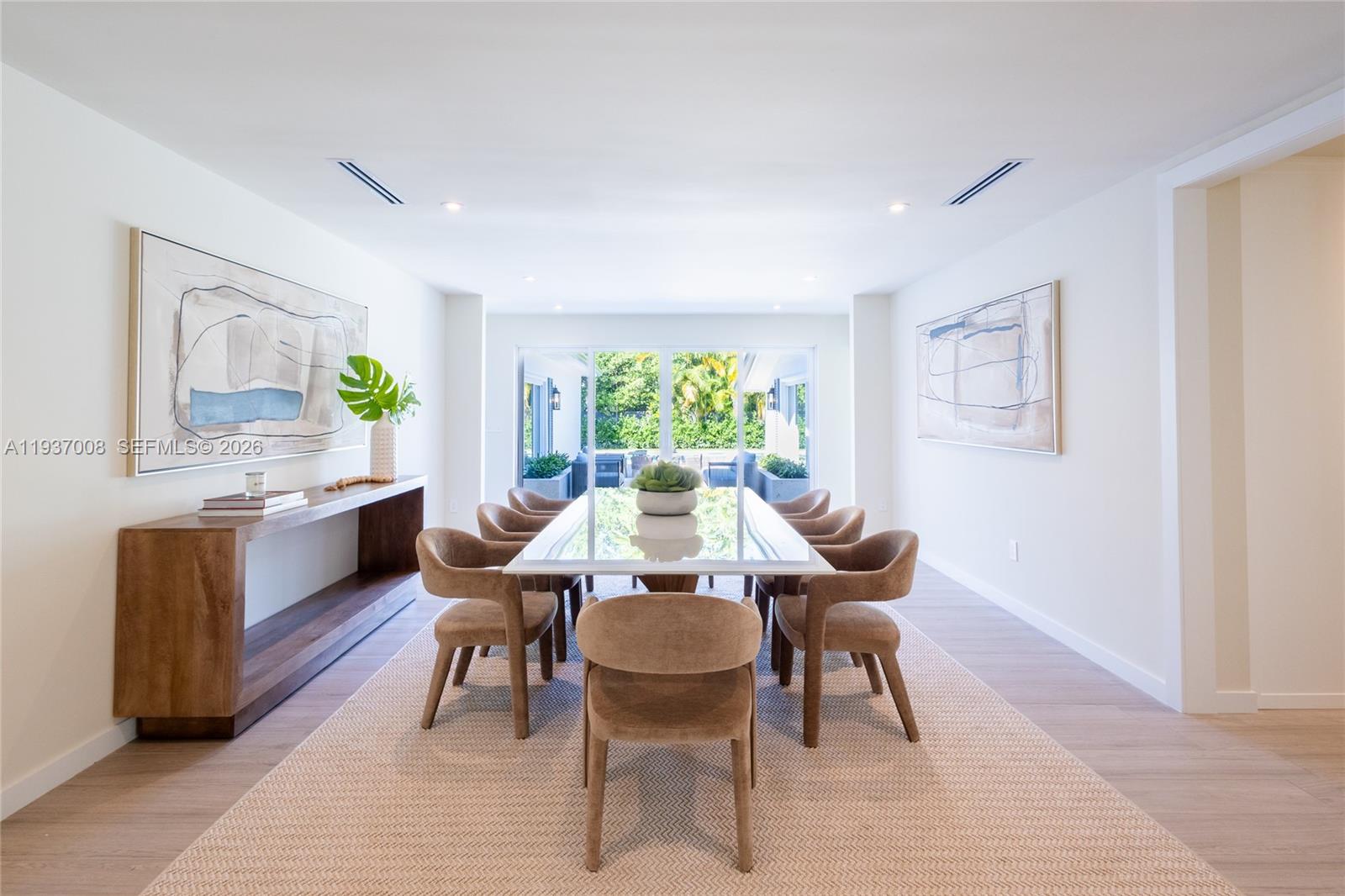 4520 Sabal Palm Road Miami, FL 33137 - Photo 2 of 22 a kitchen with a dining table chairs and window