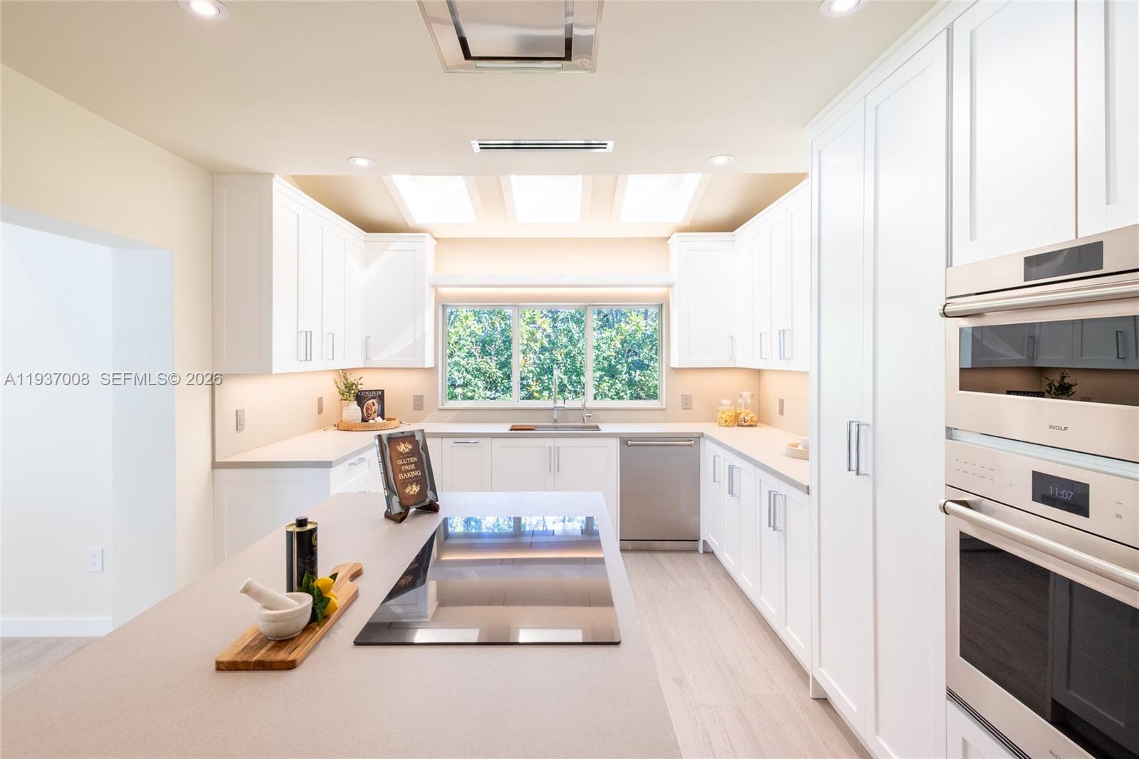 4520 Sabal Palm Road Miami, FL 33137 - Photo 5 of 22 a kitchen with a sink appliances cabinets and a window