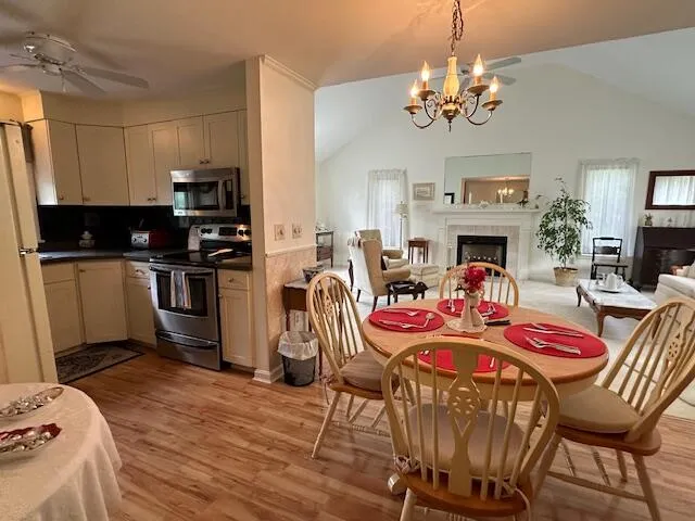a view of a dining room with furniture and chandelier