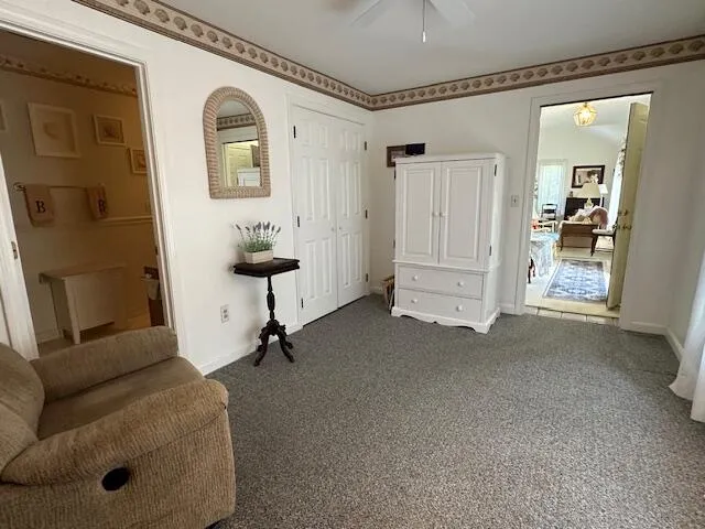a view of a livingroom with furniture and a hallway
