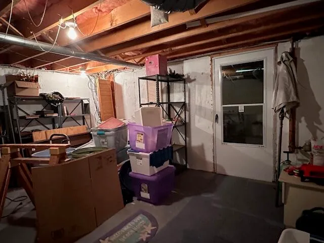 a room with water heater and a wooden closet