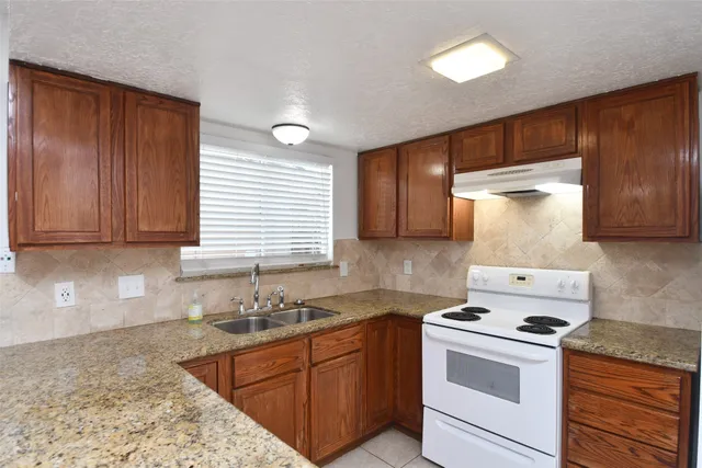 a kitchen with a stove cabinets and refrigerator