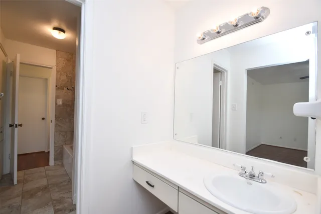 a bathroom with a bathtub and shower