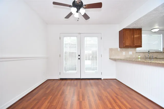 a kitchen with stainless steel appliances granite countertop a sink a stove and a refrigerator