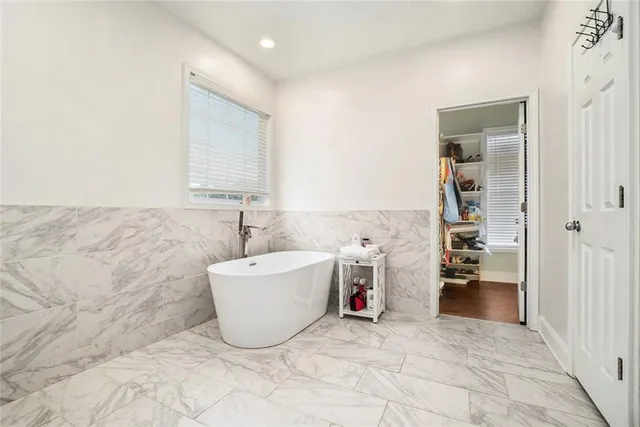 a spacious bathroom with a bathtub and sink