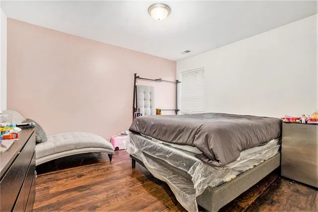 a bedroom with a bed and a couch