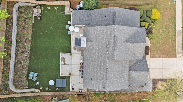 an aerial view of a house with a yard