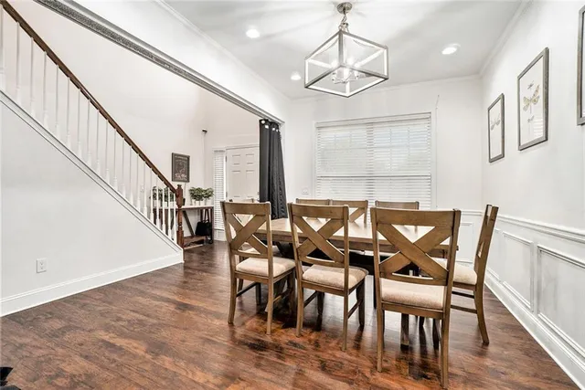 a view of a dining room with furniture a chandelier and wooden floor