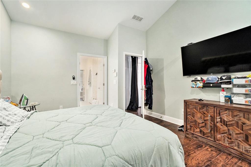 2798 Glenlocke Circle Northwest Atlanta, GA 30318 - Photo 10 of 24 a bedroom with a bed and a flat screen tv