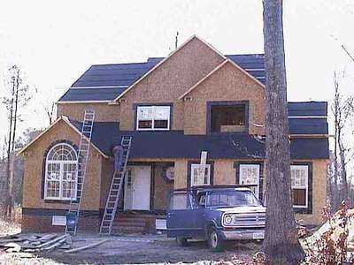 a view of a house with a yard and balcony