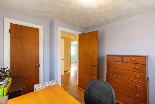 a bedroom with a bed and a dresser