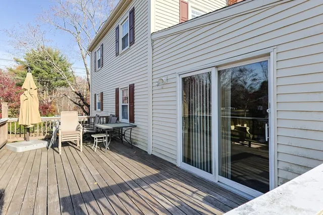 a view of a patio with table and chairs and floor with wooden floor