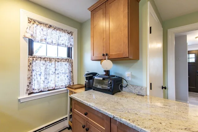 a kitchen with granite countertop cabinets and window