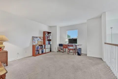a view of a livingroom with furniture and workspace