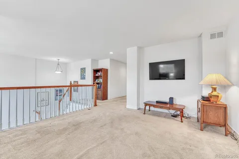 a view of a livingroom with furniture and a flat screen tv