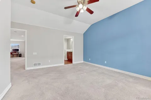 a view of an empty room with a ceiling fan