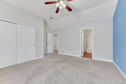 a view of an empty room with a ceiling fan