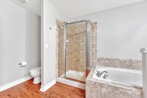 a bathroom with a tub shower and toilet