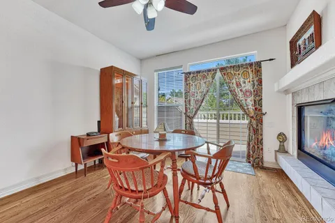 a dining room with furniture a chandelier and wooden floor