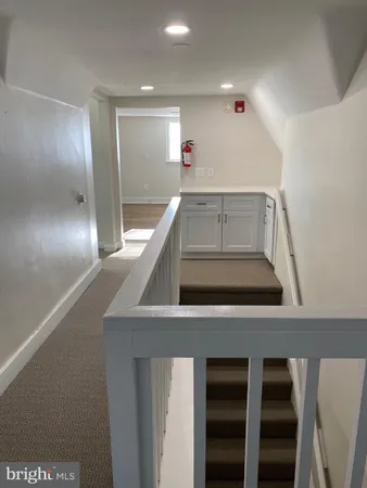 a view of a hallway with seating space