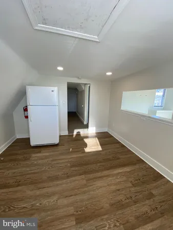 a view of a room with wooden floor and window