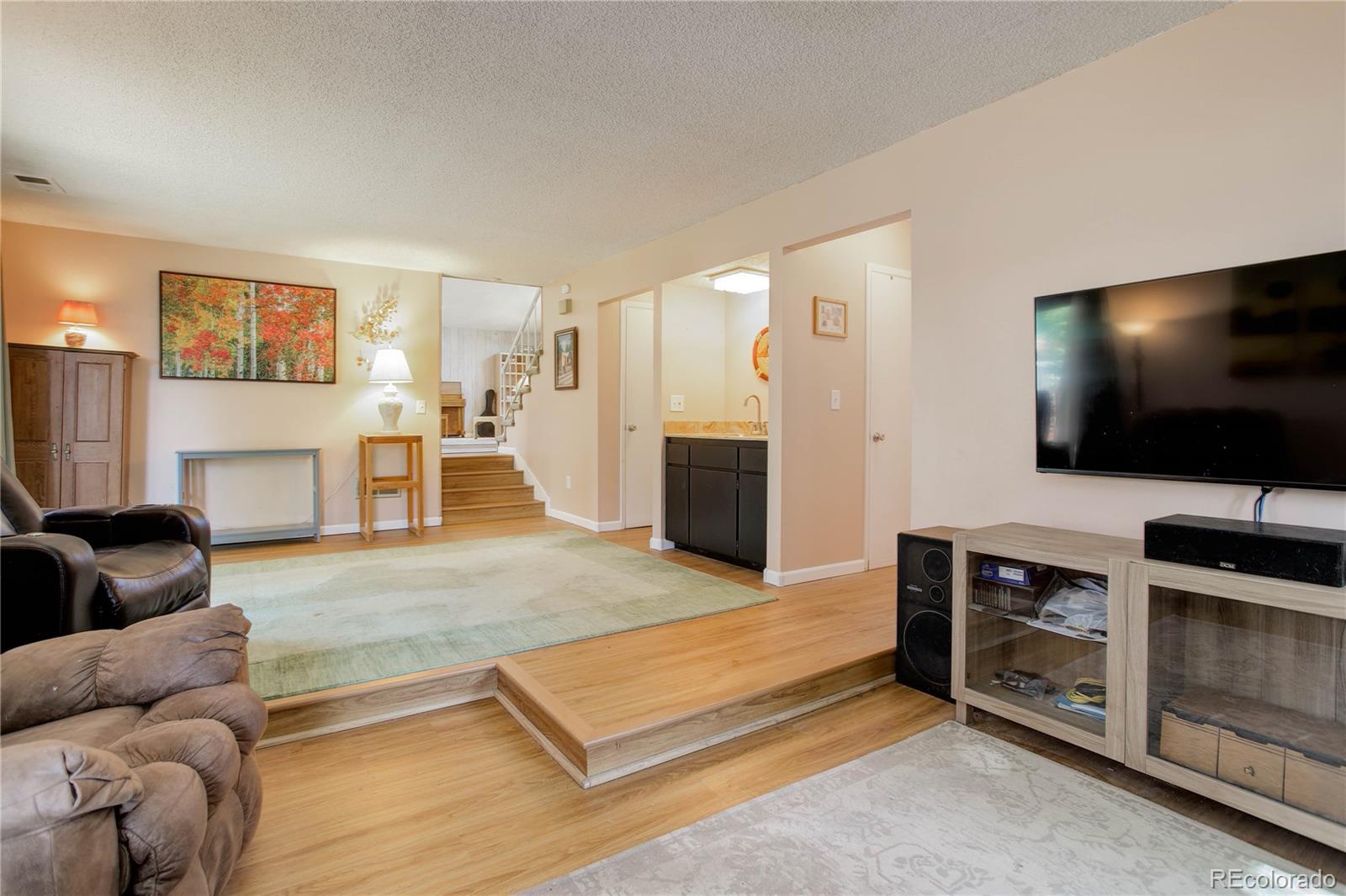 7347 South Ridgeview Drive Littleton, CO 80120 - Photo 15 of 36 a living room with furniture and a flat screen tv