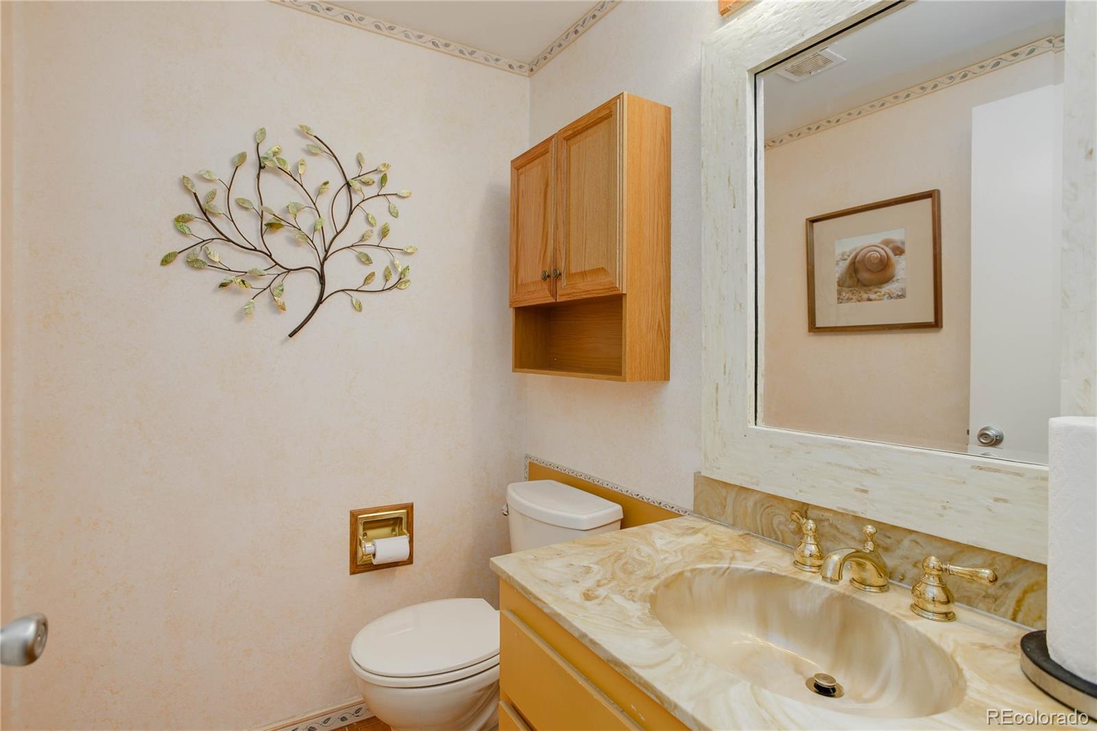7347 South Ridgeview Drive Littleton, CO 80120 - Photo 16 of 36 a bathroom with a sink vanity mirror and toilet