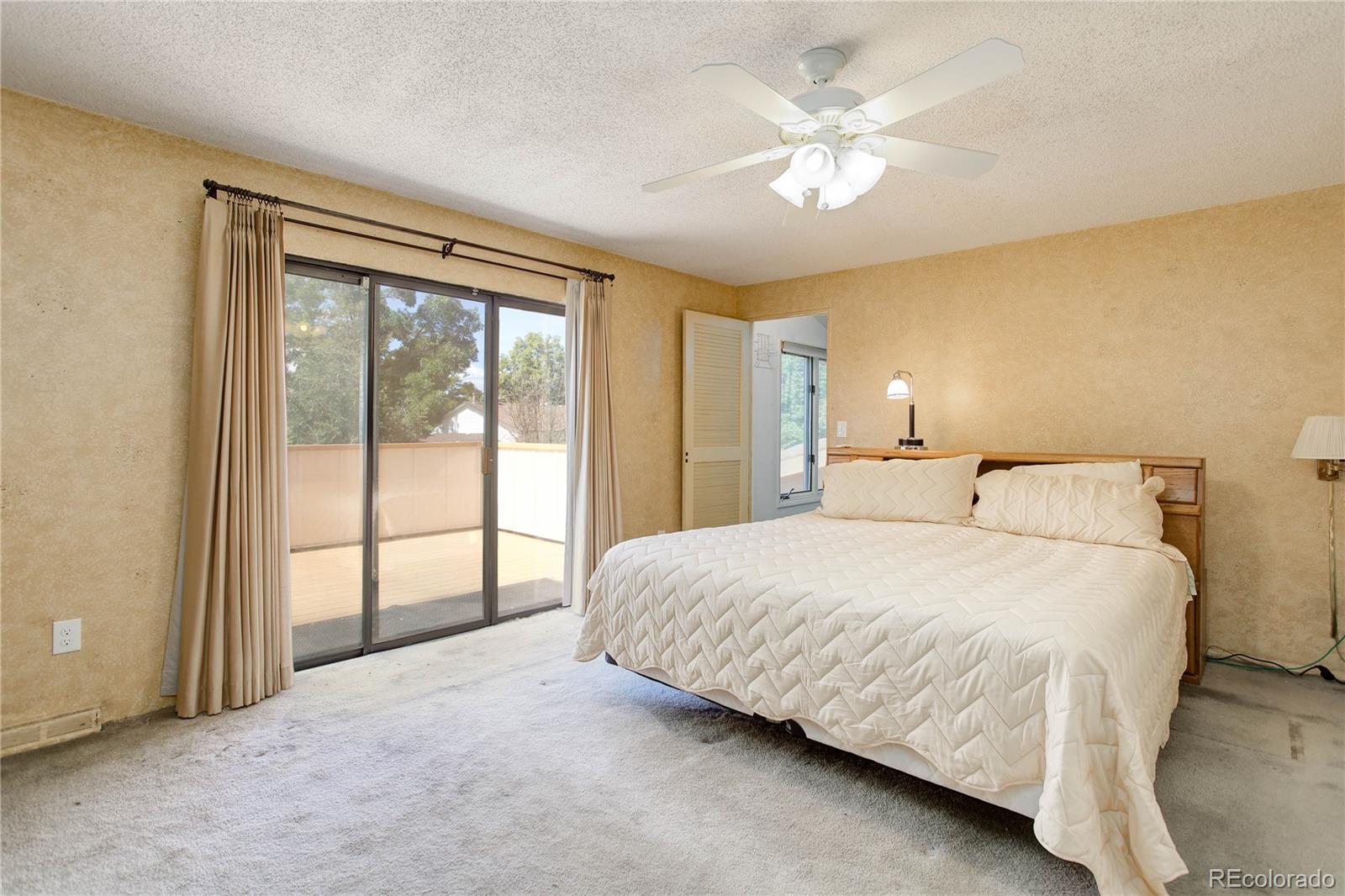 7347 South Ridgeview Drive Littleton, CO 80120 - Photo 18 of 36 a bedroom with a large bed and a large window
