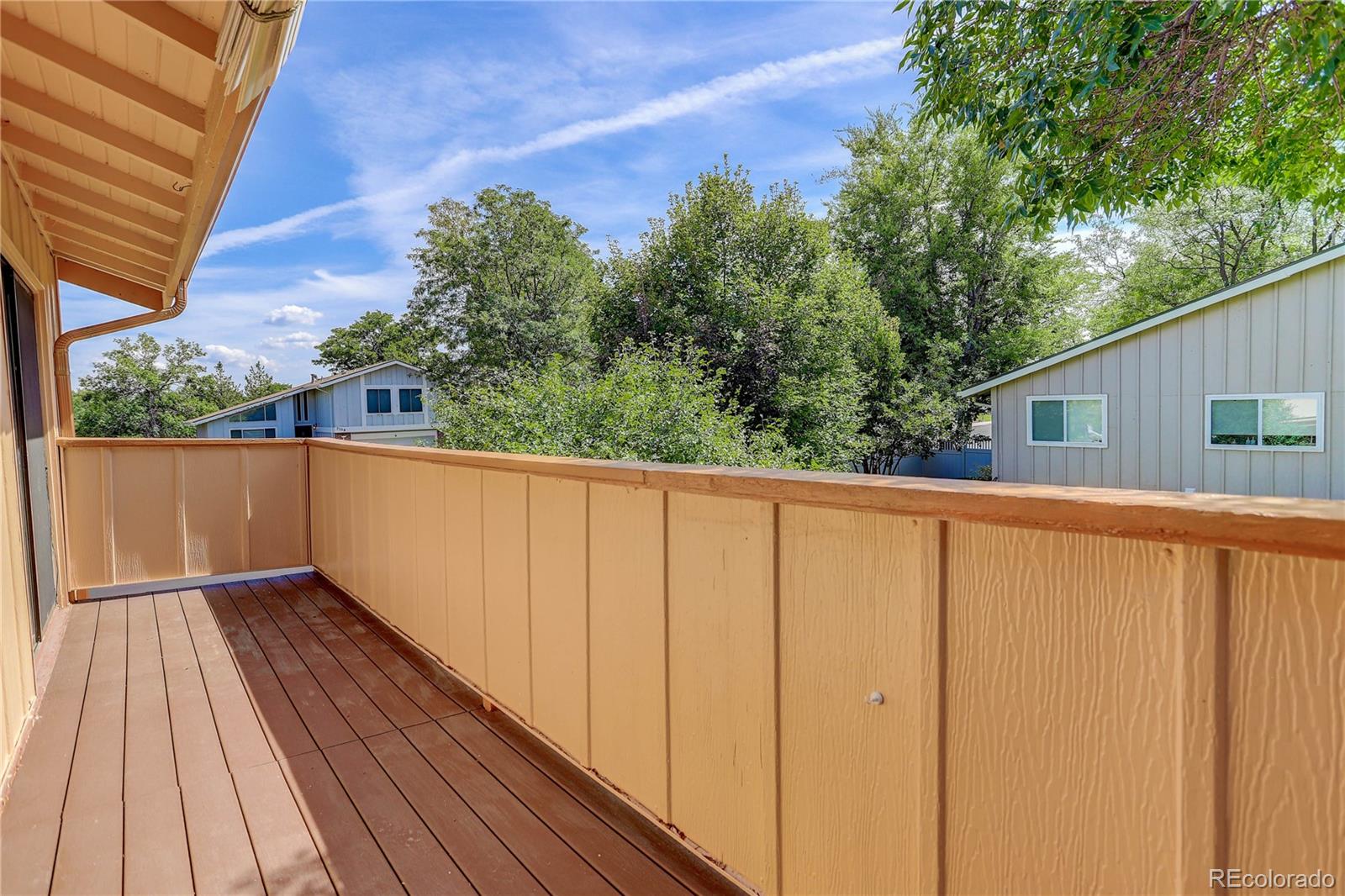 7347 South Ridgeview Drive Littleton, CO 80120 - Photo 25 of 36 a view of a balcony with wooden floor and fence