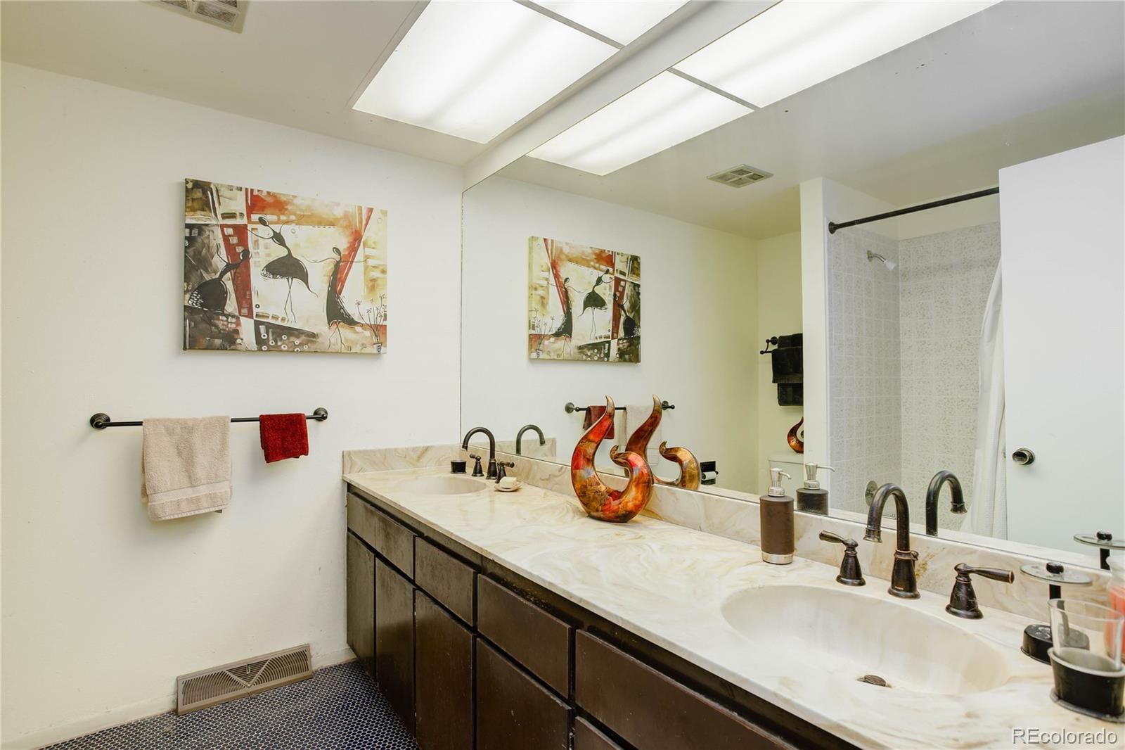7347 South Ridgeview Drive Littleton, CO 80120 - Photo 26 of 36 a bathroom with a sink mirror and vanity