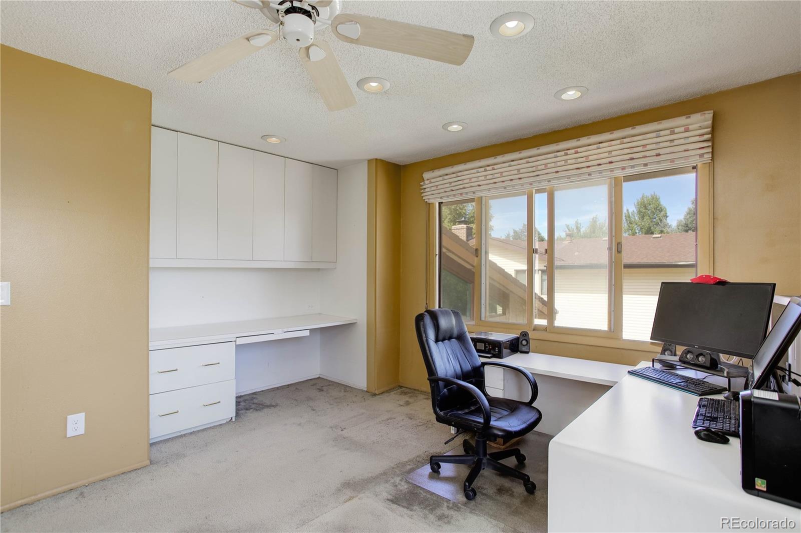 7347 South Ridgeview Drive Littleton, CO 80120 - Photo 28 of 36 a view of a workspace with furniture and a window