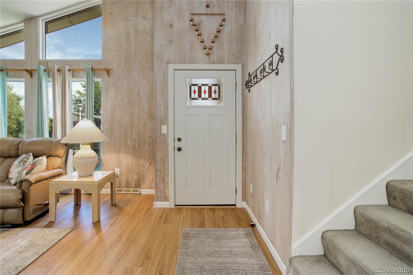 7347 South Ridgeview Drive Littleton, CO 80120 - Photo 3 of 36 a view of a hallway with furniture and wooden floor