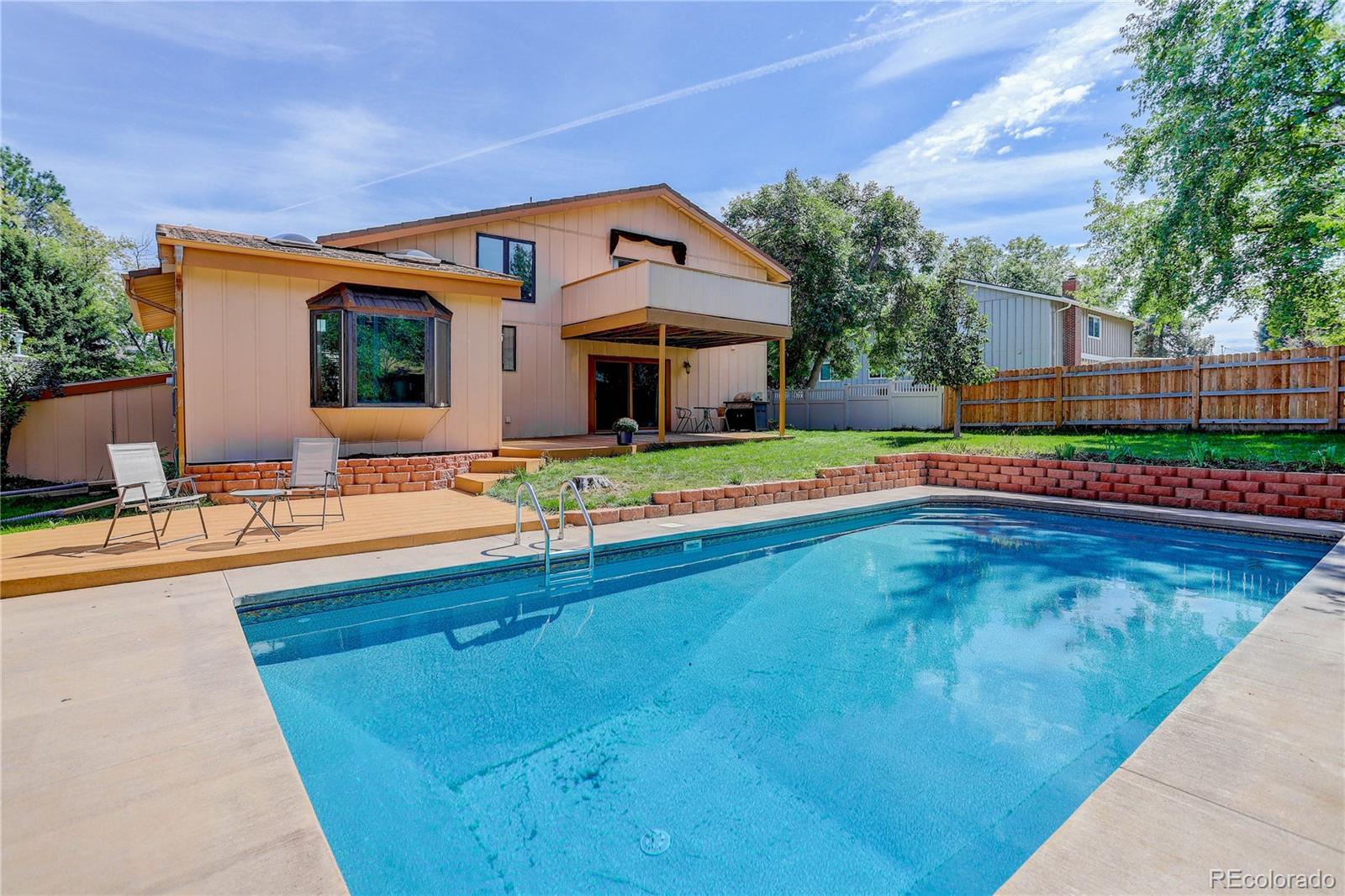 7347 South Ridgeview Drive Littleton, CO 80120 - Photo 32 of 36 a front view of house with yard and swimming pool