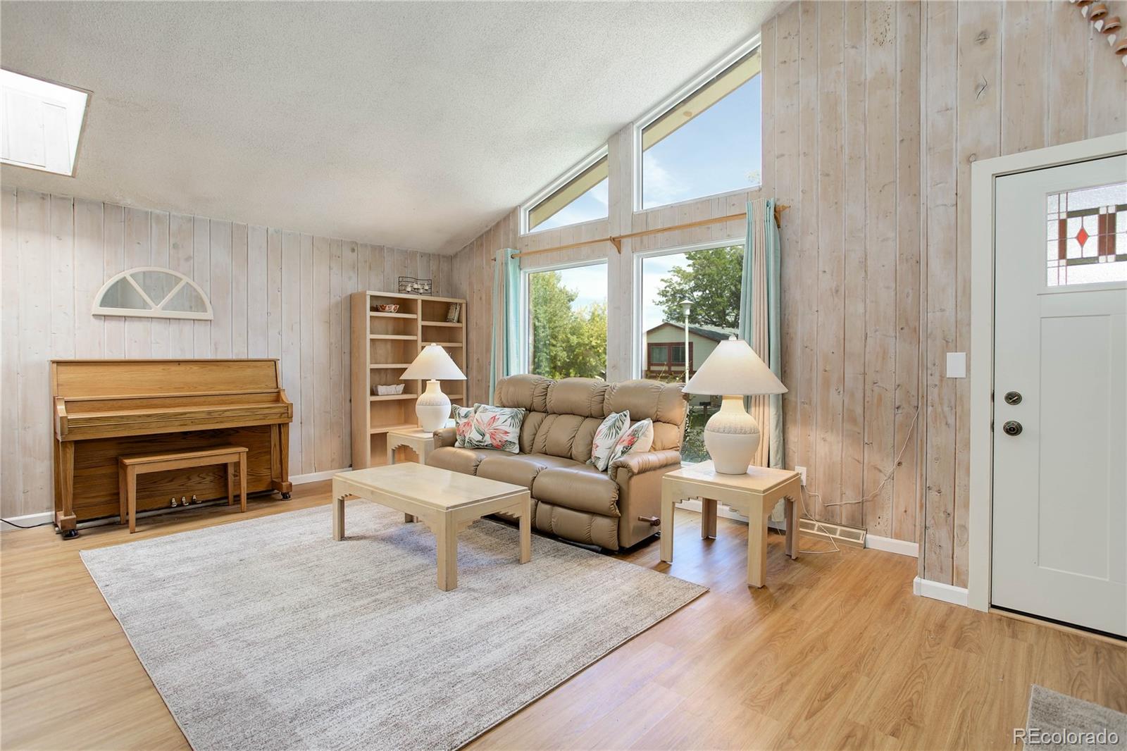 7347 South Ridgeview Drive Littleton, CO 80120 - Photo 7 of 36 a living room with furniture a fireplace and wooden floor