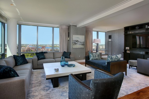 1 Avery Street, Unit 27B Boston, MA 02111 - Photo 3 of 4 a living room with furniture and a flat screen tv