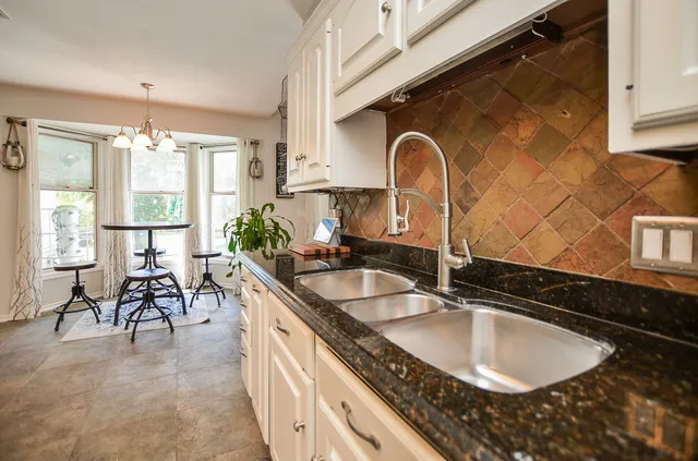 a kitchen with granite countertop a sink and a cabinets