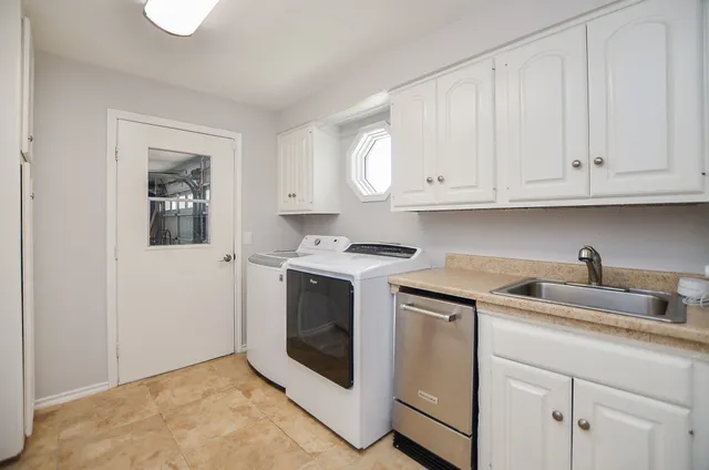 a kitchen with granite countertop white cabinets and white appliances