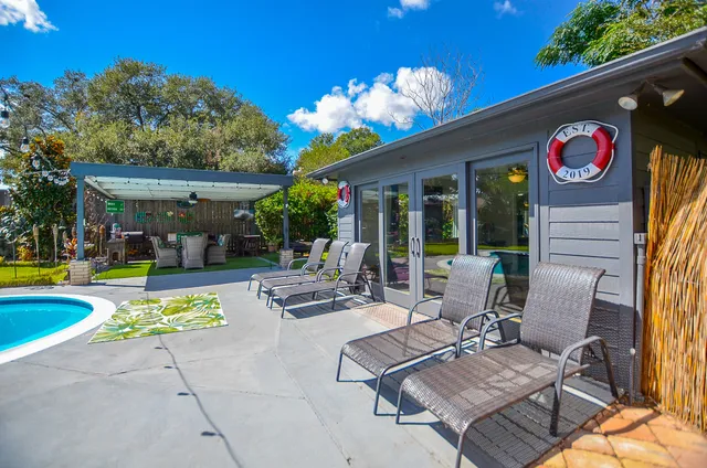 a view of a patio with swimming pool table and chairs