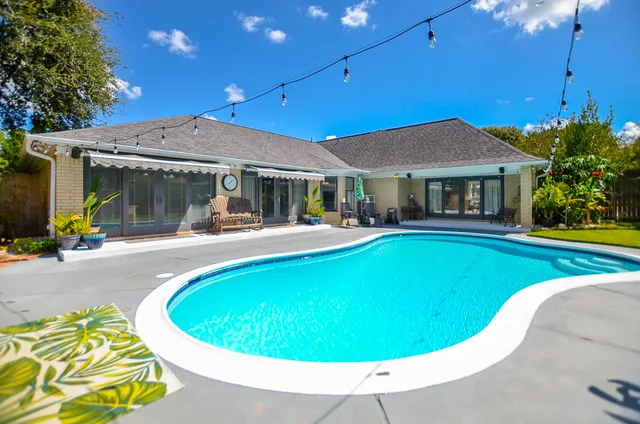 a swimming pool with outdoor seating yard and patio