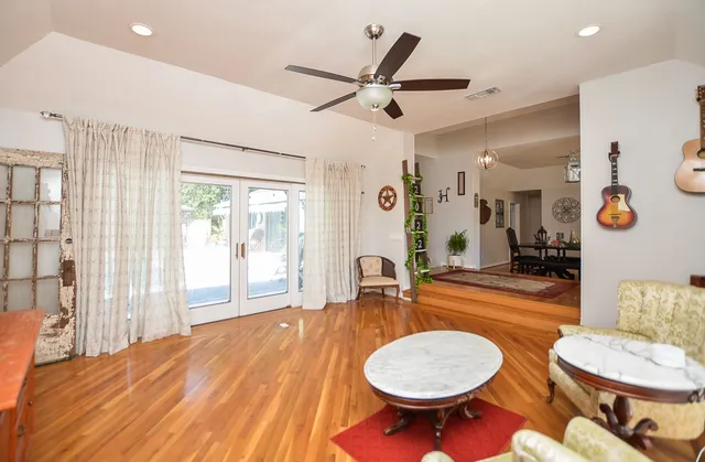 a living room with dining room and wooden floor