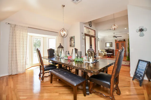 a view of a dining room with furniture and wooden floor