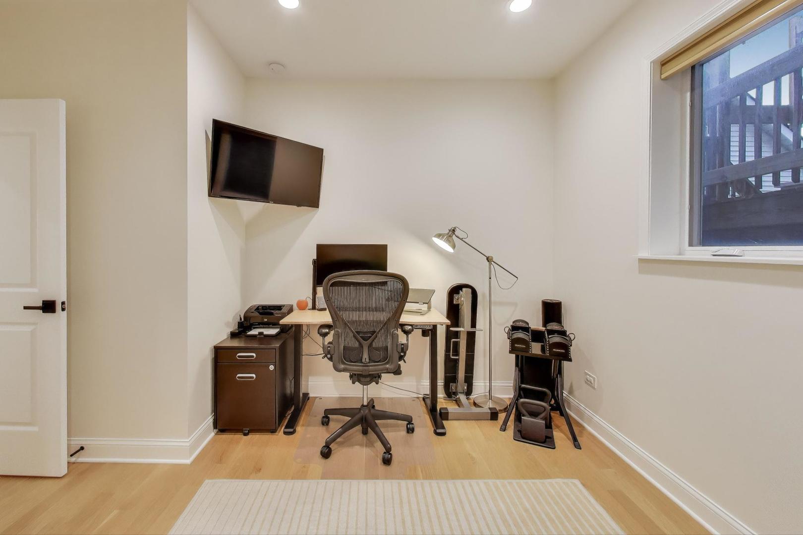 1811 South Laflin Street, Unit 2 Chicago, IL 60608 - Photo 14 of 20 a view of a workspace with furniture and a flat screen tv