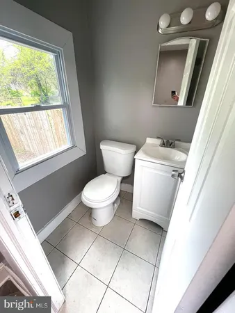 a bathroom with a toilet sink and window