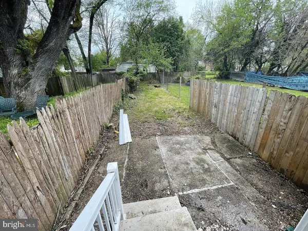 a view of deck with wooden fence and trees