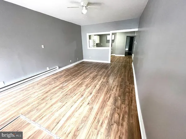 a view of a room with wooden floor and window
