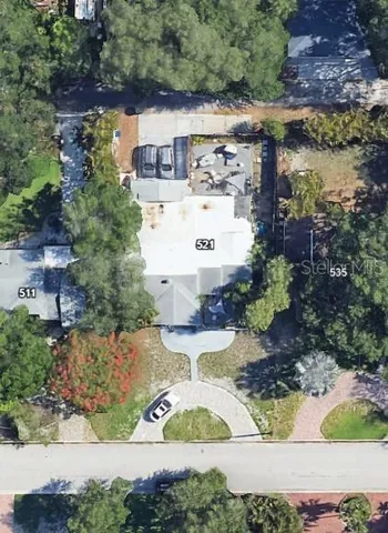 an aerial view of a house with yard swimming pool and outdoor seating